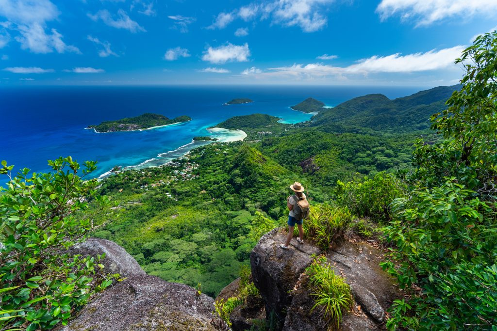 woman high above on tropical island mountain